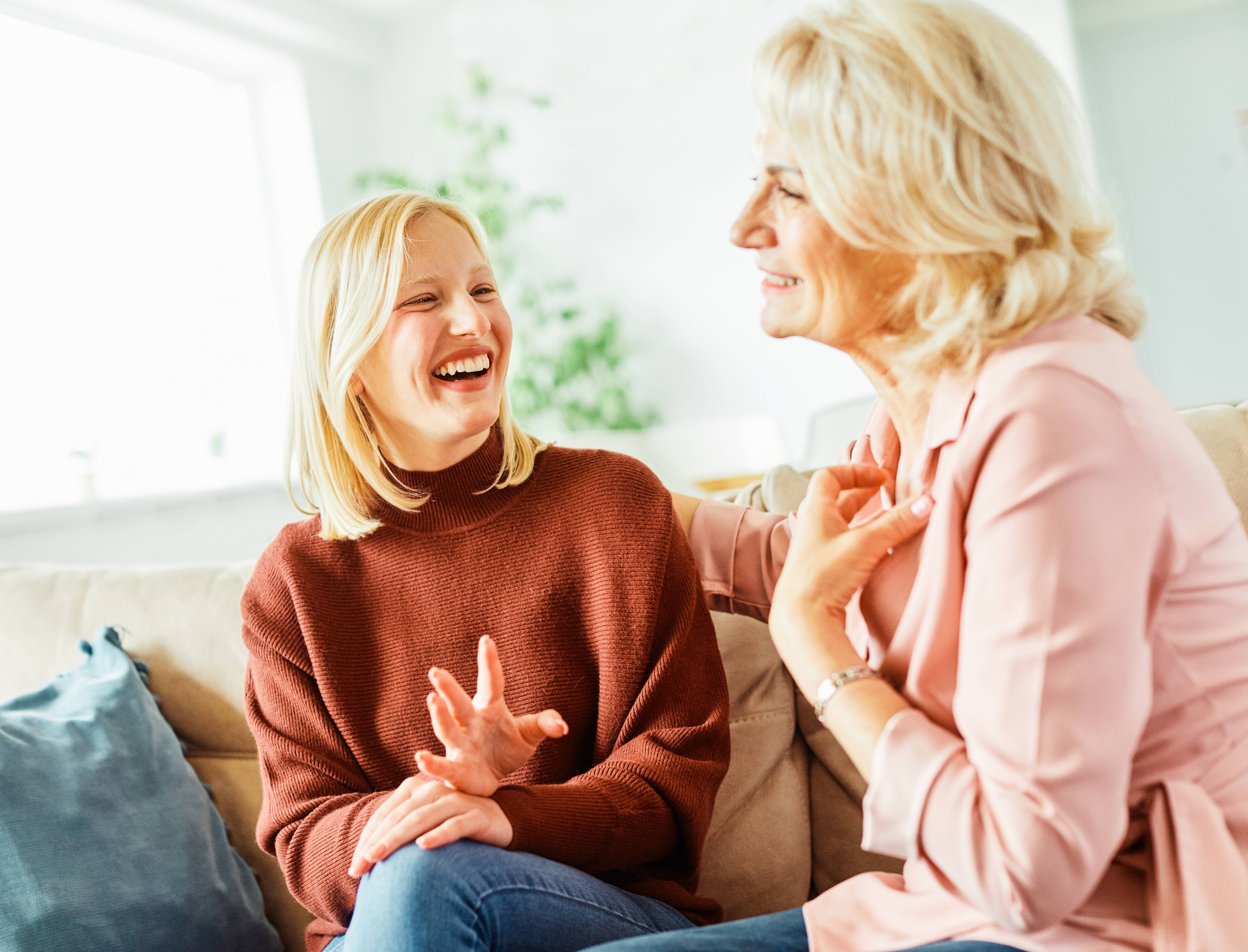 Happy mother and daughter smiling at home